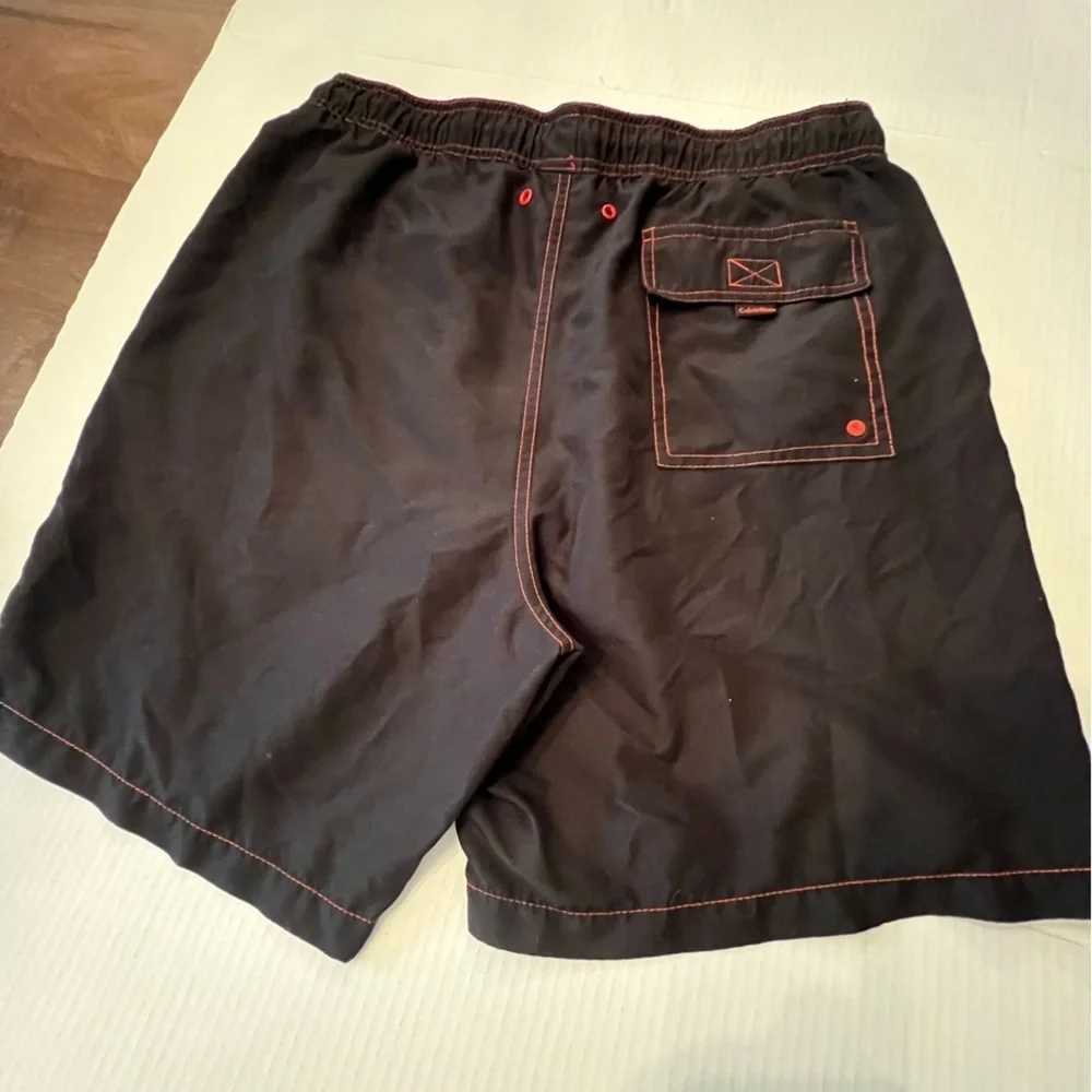 CALVIN KLEIN MENS SWIM TRUNKS. SIZE MEDIUM. BLACK WITH ORANGE STITCHING